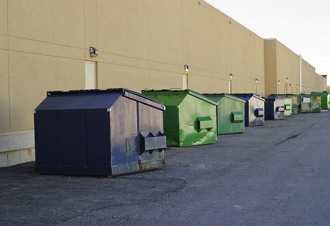 a variety of construction materials dumped haphazardly into a dumpster in Canyon Lake, CA